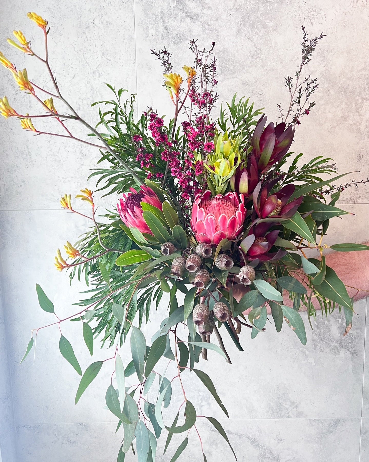 A sculptural, hand-tied bouquet of native flowers including Proteas, gum nuts, kangaroo paw and seasonal blooms, delivered fresh across Melton by The Flowered Heart