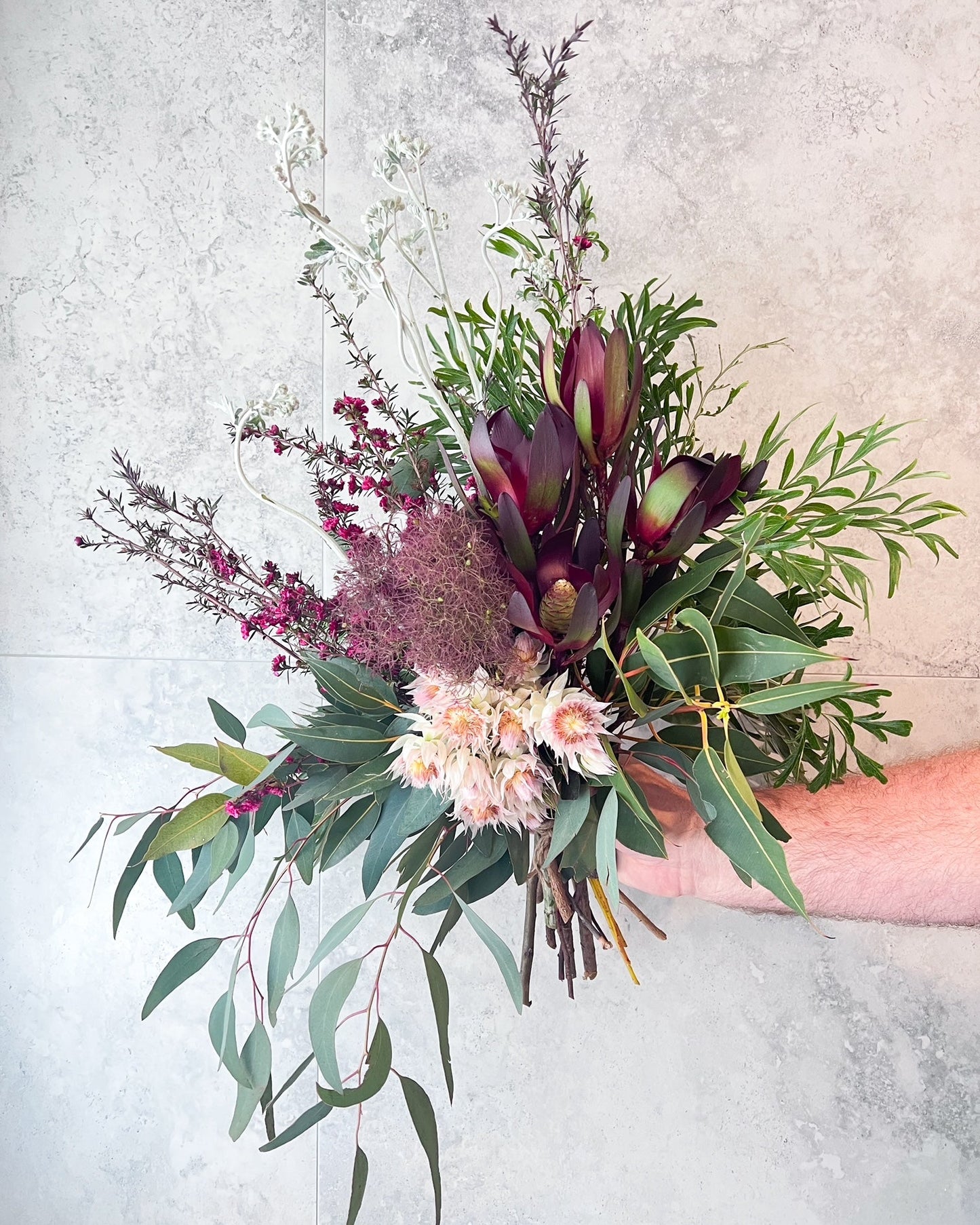 A textural, hand-tied bouquet of native flowers including smoke bush, blushing bride, gum and seasonal blooms, delivered fresh across Melton by The Flowered Heart