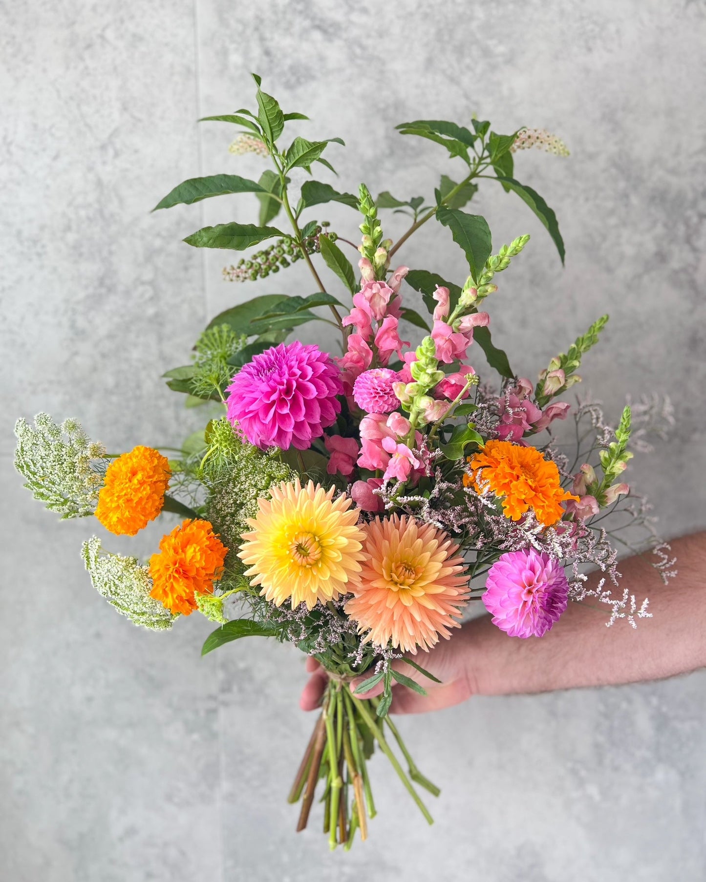 A bright, hand-tied bouquet of pretty flowers including marigolds, dahlias and seasonal blooms, delivered fresh across Melton by The Flowered Heart
