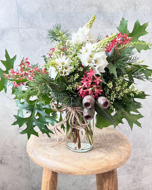 A christmas, jar arrangement of fresh flowers including christmas bush, gumnuts and seasonal blooms, available  for same day flower delivery in Melton and surrounding areas by The Flowered Heart
