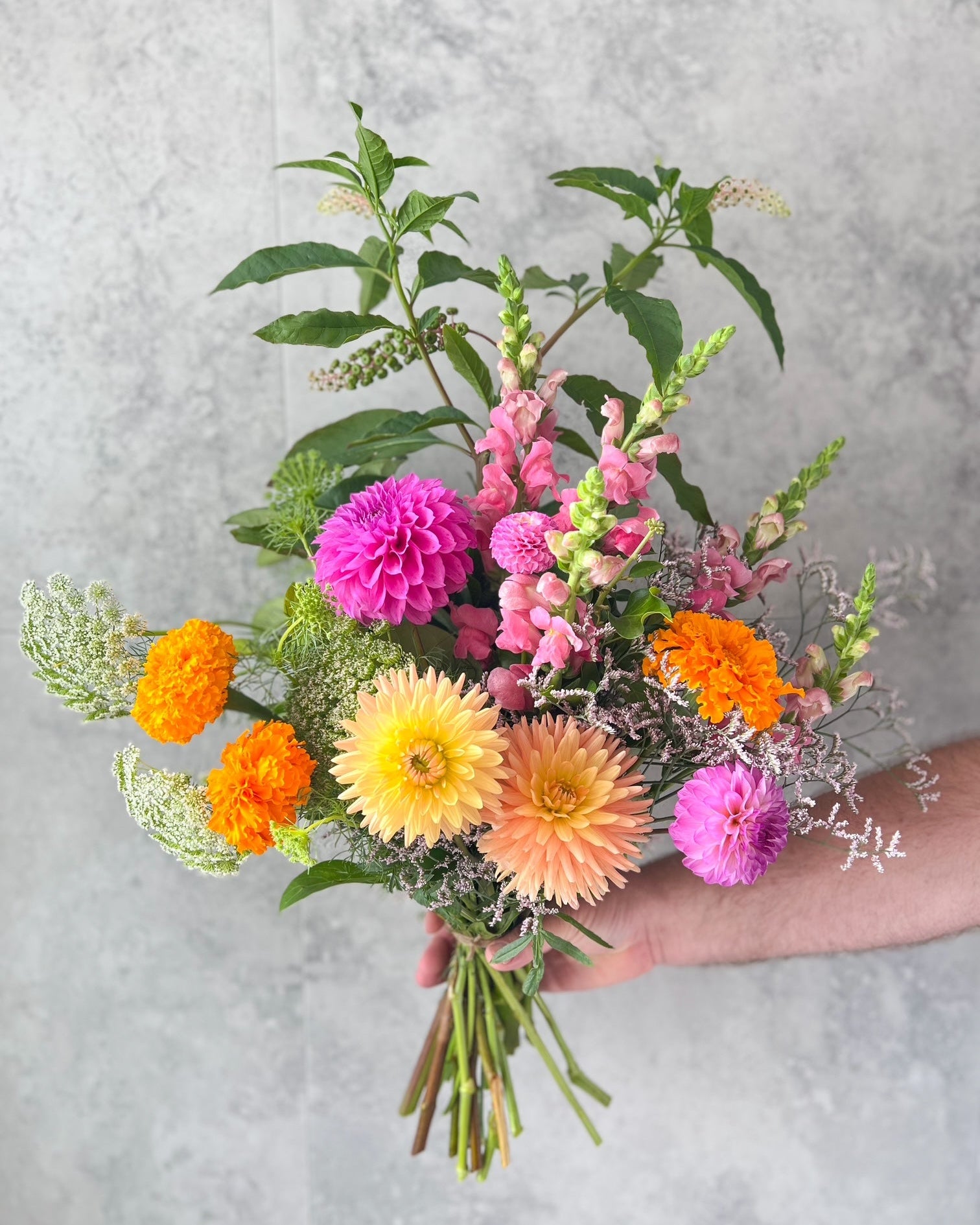 A bright, hand-tied bouquet of pretty  flowers including marigolds, dahlias and seasonal blooms, delivered fresh across Melton by The Flowered Heart