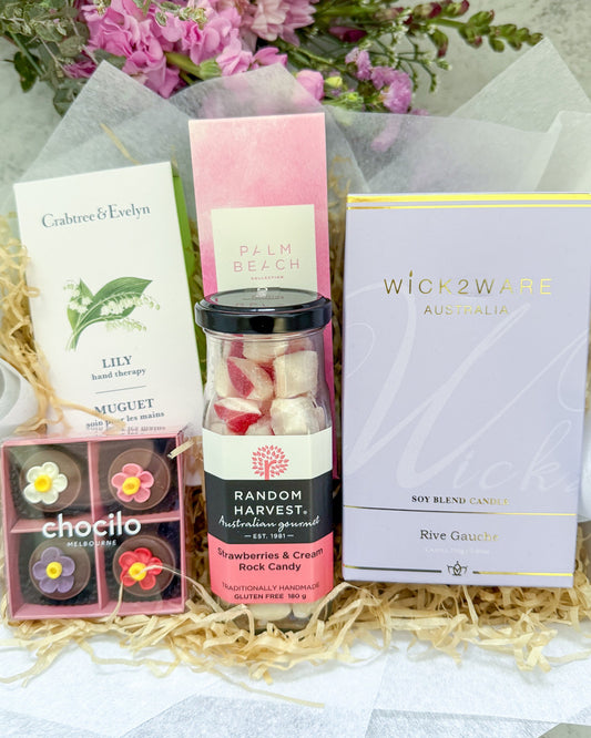Sending You a Smile Gift Hamper contains a lovely collection of gifts including Wick 2 Ware candle, Palm Beach Diffuser, Chocilo Chocolates, Rock Candy and Crabtree and Evelyn Hand Cream.